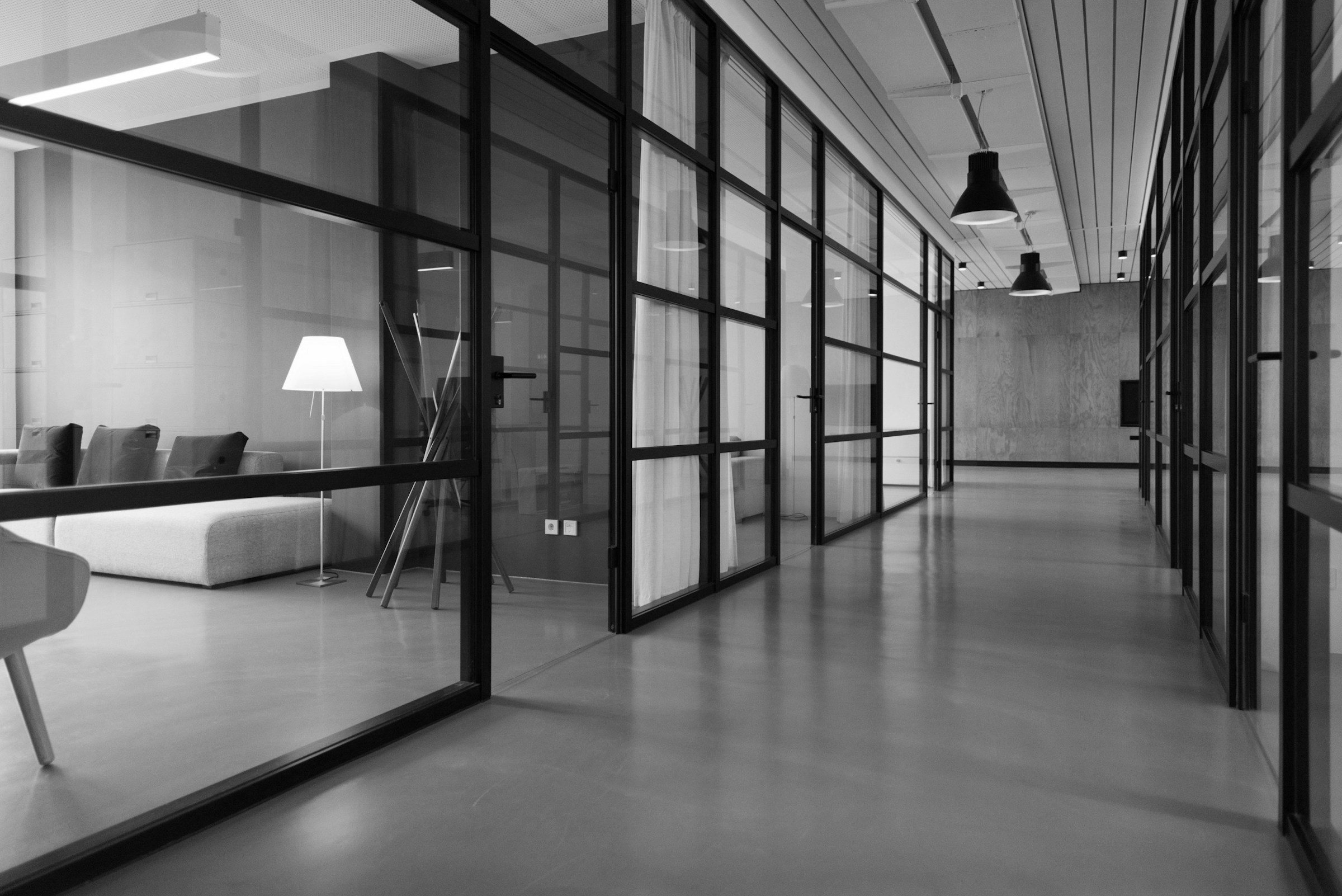 A glass-walled office corridor